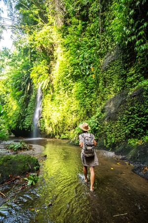 Woman near waterfal on Bali, IndonesiaÂ の写真素材
