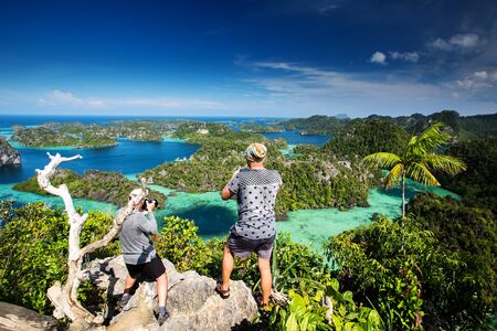 Tourist on the top of Puncak Harfat viewpoint, Raja Ampat, Indonesiaの写真素材