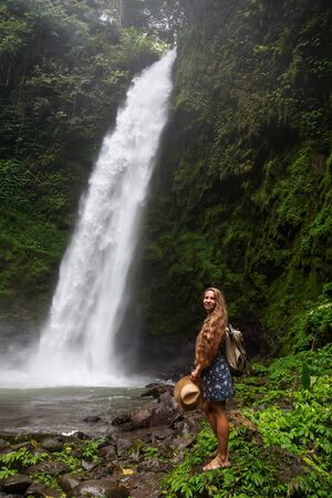 Woman near Nung Nung waterfal on Bali, Indonesiaの写真素材
