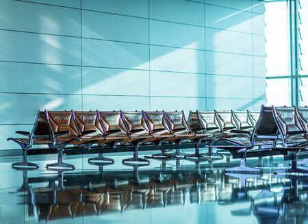 Empty chairs in the departure hall at airportの写真素材