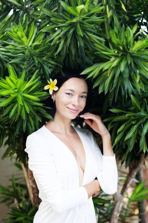 Beautiful woman by the ocean at sunsetの写真素材