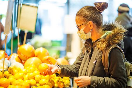 Caucasian woman shopping wearing maskの写真素材