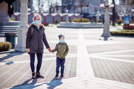 Mother and her son outdoor wearing masks の写真素材
