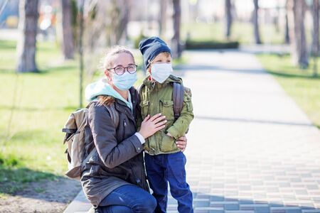 Mother and her son outdoor wearing masks の写真素材