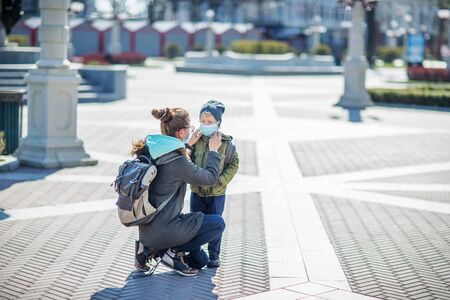 Mother and her son outdoor wearing masksの写真素材
