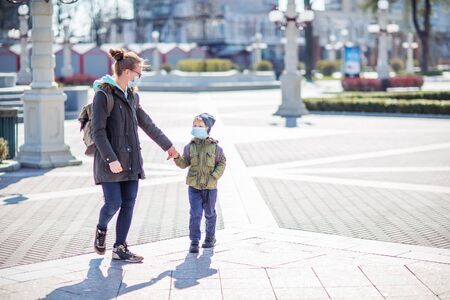 Mother and her son outdoor wearing masksの写真素材