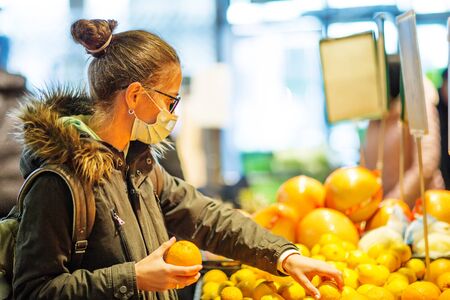 Caucasian woman shopping wearing maskの写真素材