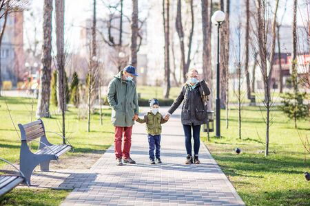 the whole family outdoor wearing masksの写真素材