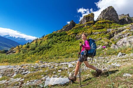 Woman trekking in Caucasus mountains in Ushba region, Geoirgiaの写真素材