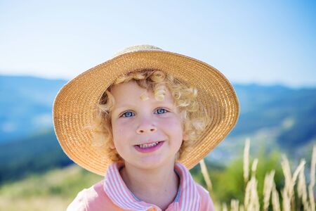 boy in a straw hat in summerの写真素材