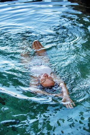 Beautiful woman in the nature pool