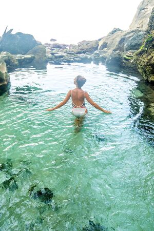 Beautiful woman in the nature poolの写真素材