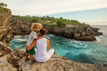 Mom with son by the oceanの写真素材