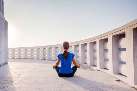 Woman is doing yogastic excersises in temple in the mountainsの写真素材