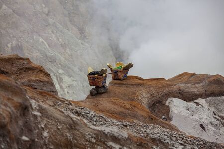 People mining sulphur in Ijen volcano, Java , Indonesiaの写真素材