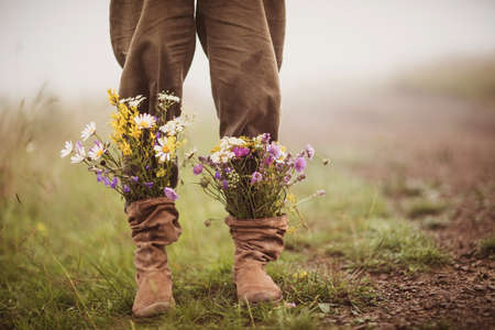 garden flowers in boots in autumn seasonの写真素材