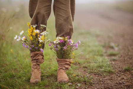 garden flowers in boots in autumn seasonの写真素材