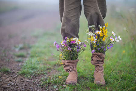 garden flowers in boots in autumn seasonの写真素材