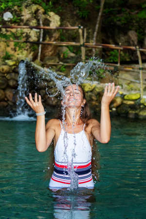 Beautiful woman in the nature poolの写真素材