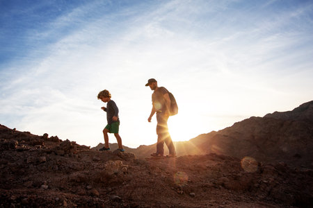 Dad with son in the mountains in the desertの写真素材