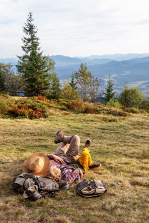 Happy family resting in the mountains in autumnの写真素材