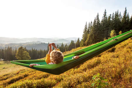 Boy hiker resting in the mountains in autumnの写真素材