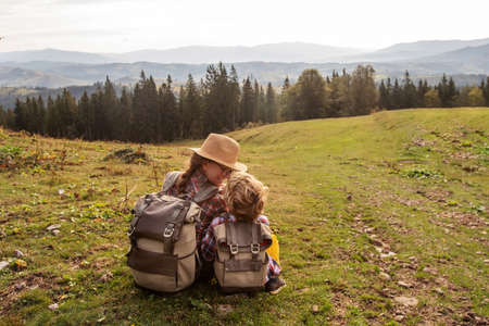 Happy family resting in the mountains in autumnの写真素材