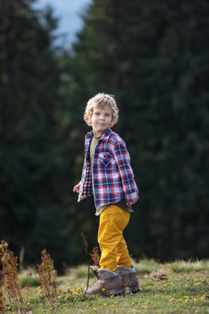 Boy hiker resting in the mountains in autumnの写真素材