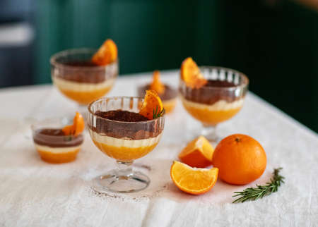 Homemade tiramisu with tangerines on a tableの写真素材