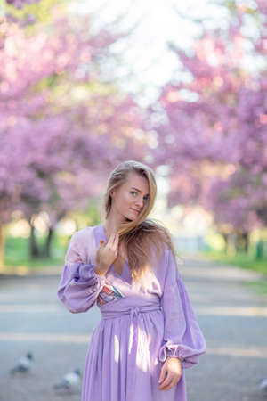 Beautiful woman in a sakura gardenの写真素材
