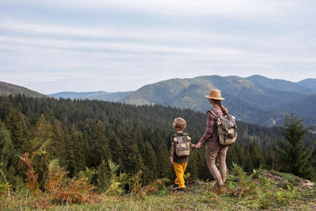 Happy family resting in the mountains in autumn