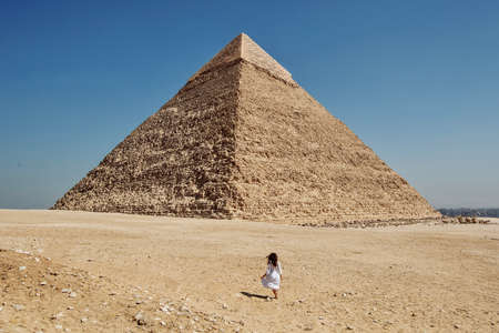Beautiful woman near the ancient pyramids of Egyptの写真素材