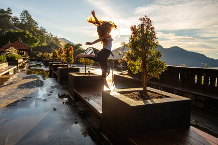 Woman doing yoga at dawn near a volcano on the island of Bali
