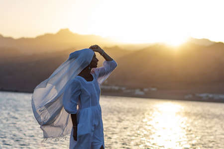 Beautiful woman relaxes by the seaの写真素材