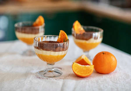 Homemade tiramisu with tangerines on a tableの写真素材