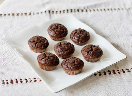 Homemade chocolate muffins on a wooden tableの写真素材