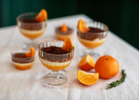 Homemade tiramisu with tangerines on a tableの写真素材