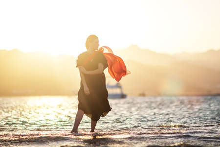 Beautiful woman relaxes by the seaの写真素材
