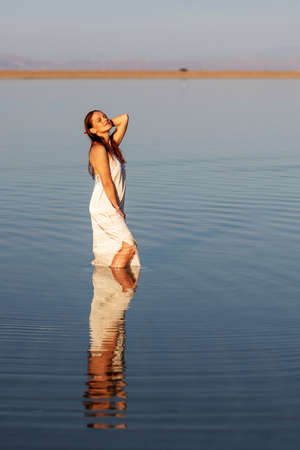 Beautiful woman relaxes by the seaの写真素材