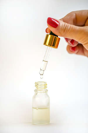 A bottle with a pipette for essential oilsの写真素材