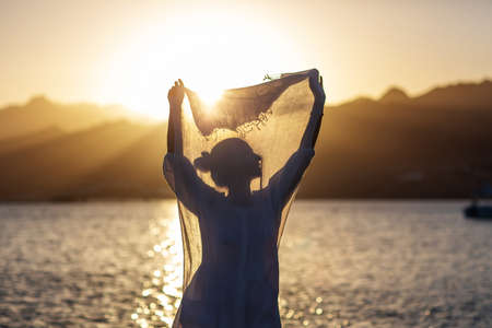 Beautiful woman relaxes by the seaの写真素材