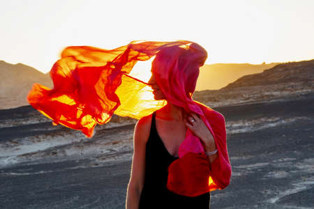 Beautiful woman resting in the desertの写真素材