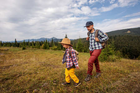 Happy family resting in the mountains in autumnの写真素材