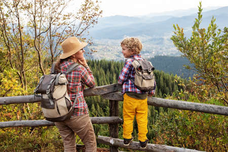 Happy family resting in the mountains in autumnの写真素材