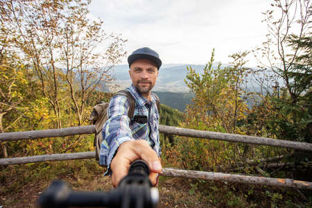 man hiker resting after climbing at sunsetの写真素材