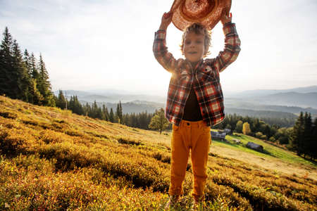 Boy hiker resting in the mountains in autumnの写真素材