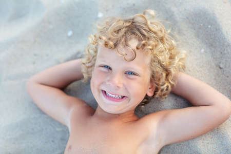 Portrait of a boy at sunset by the seaの写真素材