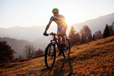 Cyclist in the autumn mountainの写真素材
