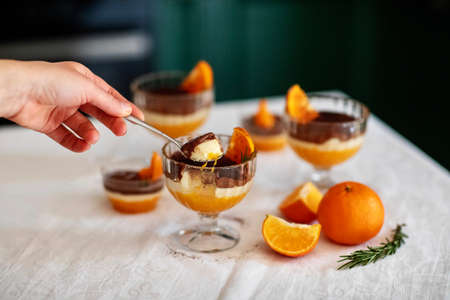 Homemade tiramisu with tangerines on a tableの写真素材