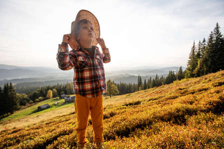 Boy hiker resting in the mountains in autumnの写真素材